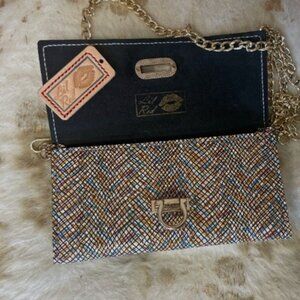 Tri-fold leather wallet with strap crossbody and wristlet